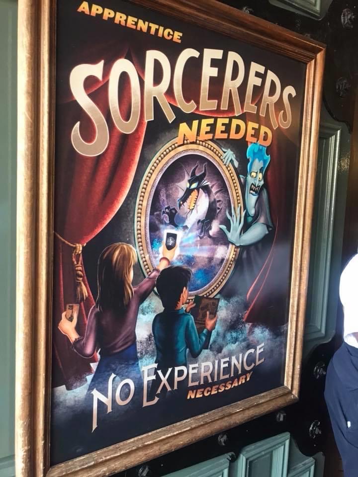 A poster that says “Sorcerers Needed - No Experience necessary”
It shows two children using cards to activate the screens 